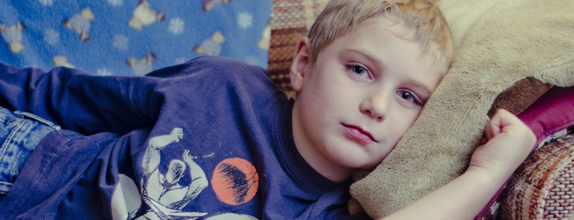 Boy lying on a sofa