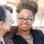 Two women smiling at each other