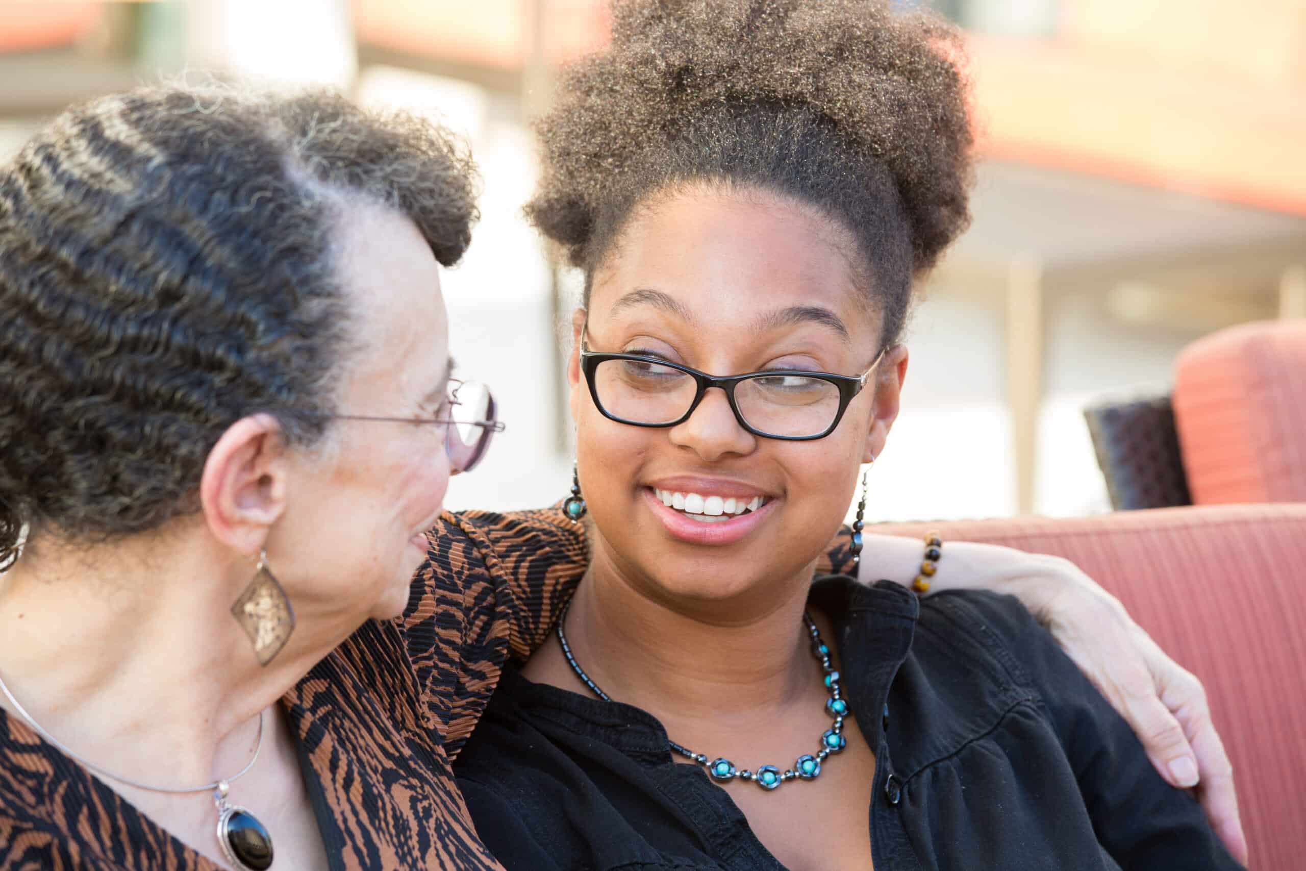 Two women smiling at each other