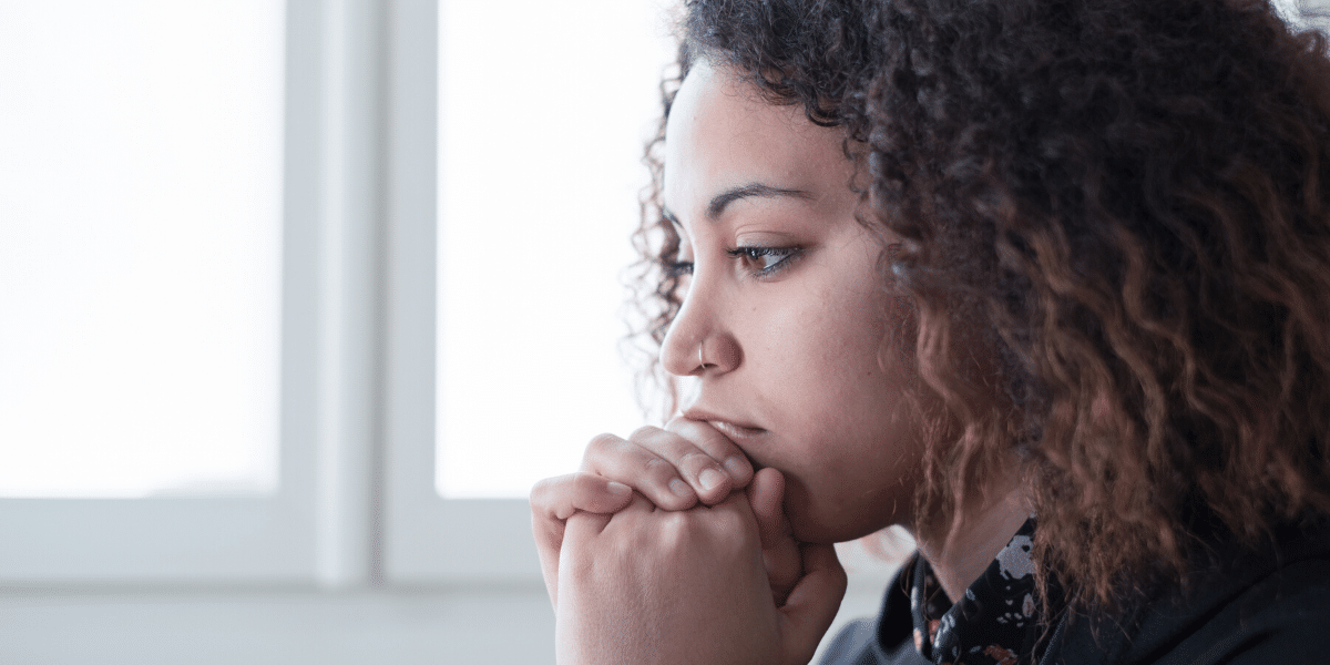 Women looking down leaning on hands
