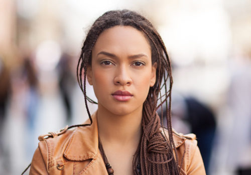 Woman in high street looking into camera