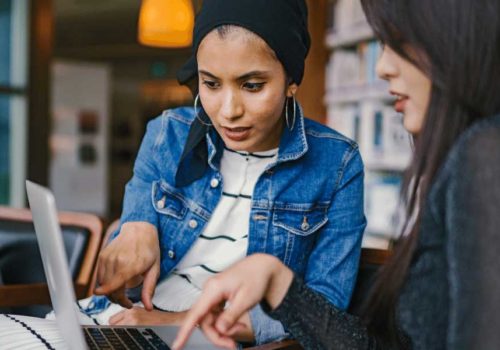 Two women looking-at-a-laptop-together