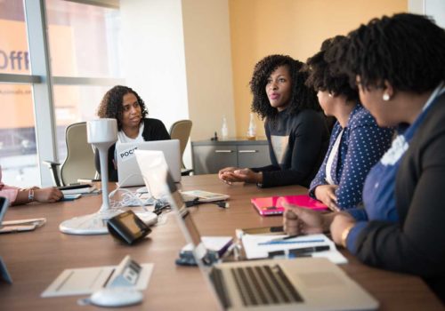 Four women in a conference room Four women in a conference room