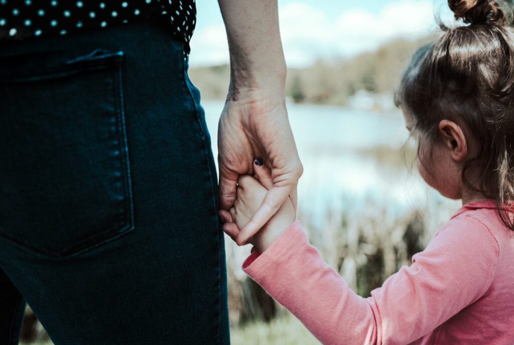 Mum holding child's hand