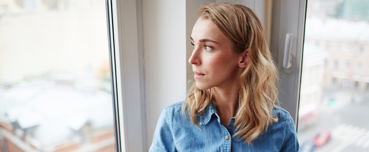 Woman looking out of window