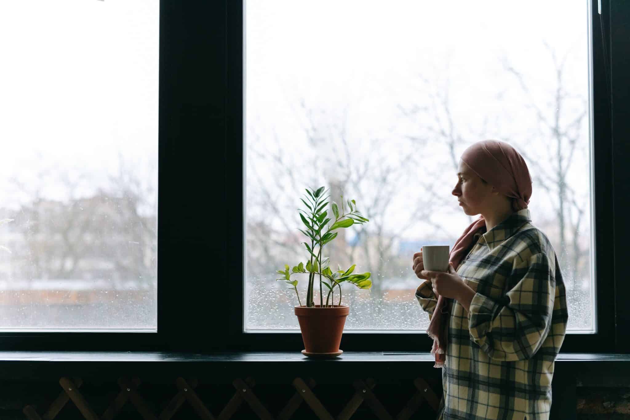 Woman standing by window